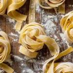 Multiple gluten free tagliatelle nests with flour dust